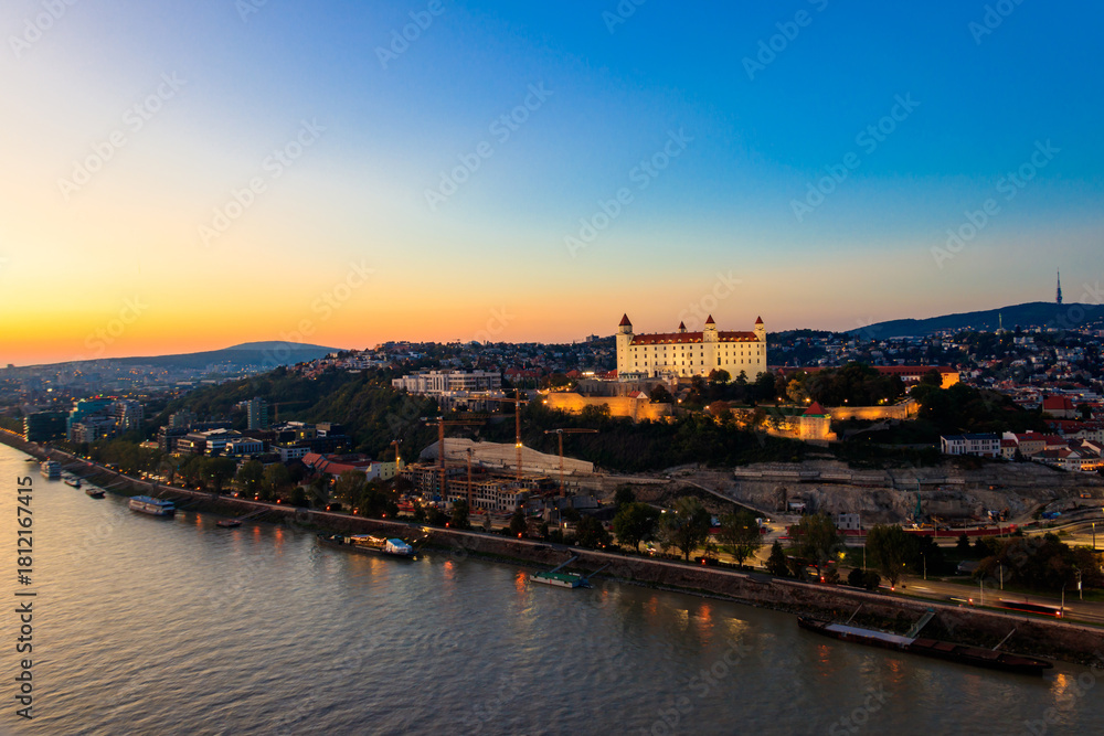 Obraz premium View of Bratislava castle, old town and the Danube river from observation deck the bridge in Bratislava, Slovakia at night