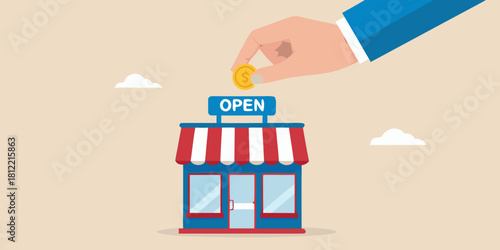 Hand drops coin into open store for business investment