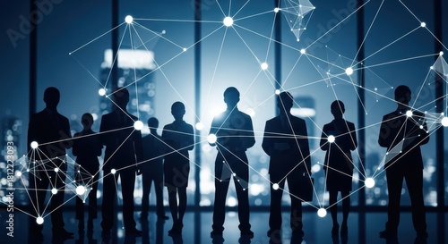 Business professionals silhouetted in office at night with network lines overlaid creating a sense of connectivity and technology