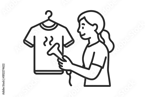 Woman using a handheld garment steamer on a wrinkled t-shirt hanging on a clothes hanger