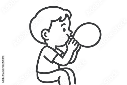 Young child inflating a rubber balloon for a festive occasion or fun activity