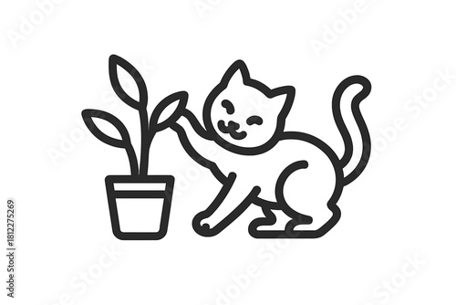 A mischievous domestic kitten batting at the leaves of a small potted indoor houseplant