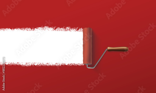 Paint roller revealing a clean white stripe on vibrant red wall