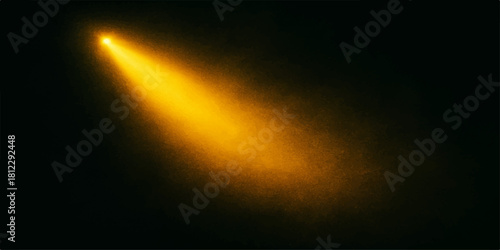 Golden light beam shining down on a dark background creates dramatic effect