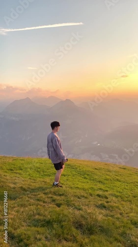 Sunset hike with a person walking on the trail and amazing view over Lake Lucerne on the Stoos