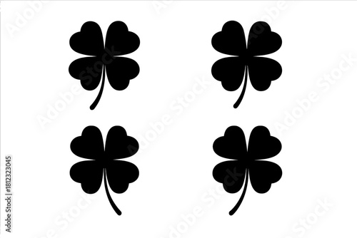 Four black four-leaf clover silhouettes representing luck and fortune symbols