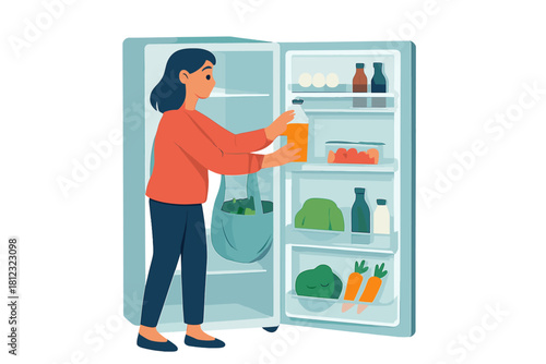 Young woman stocking the fridge with healthy food items after grocery shopping