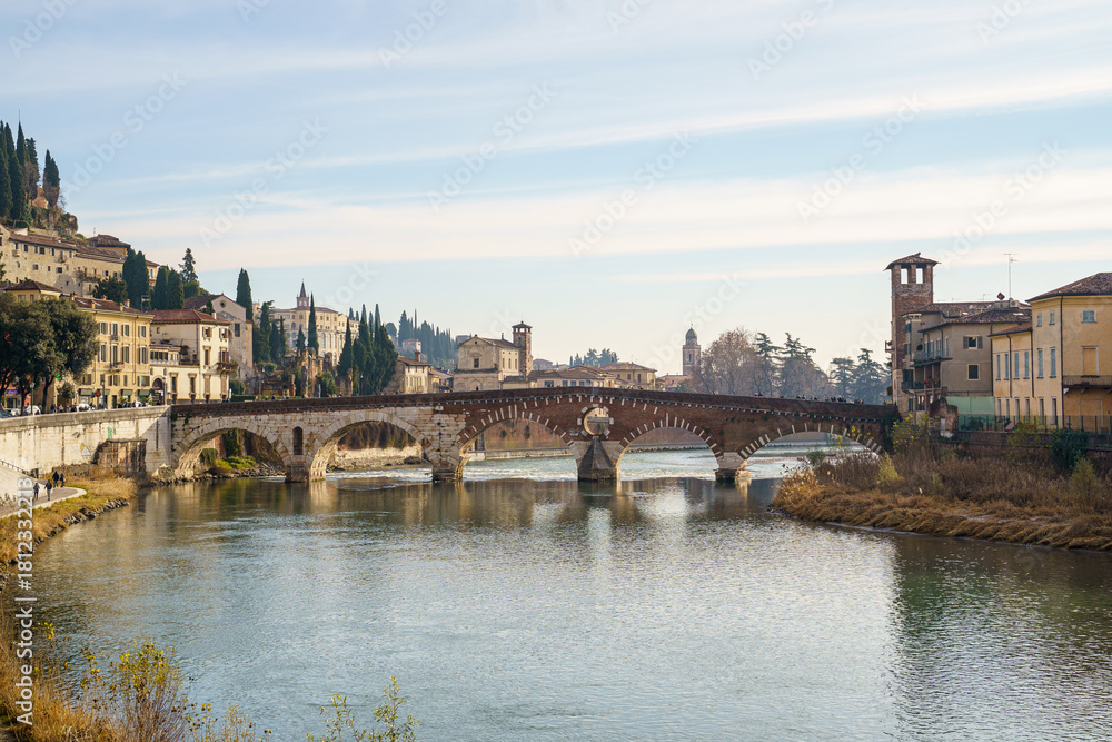 Fototapeta premium The Ponte Pietra bridge over the Adige River in Verona, Italy, and part of the city