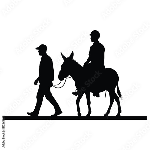 Silhouette of a man leading a donkey with a rider on top