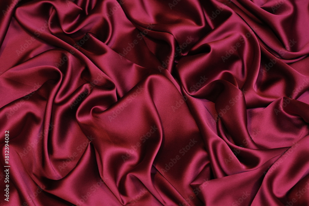 Obraz premium Close-up of soft, flowing maroon fuchsia Charmeuse satin texture. Ideal luxurious background for high-end fashion, beauty, or celebration themes.