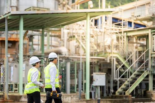 power plant and industrial plant, male and female engineers wearing reflective vests, blueprints, toolboxes analyze energy outputs, planning innovations that will enhance global energy exports.