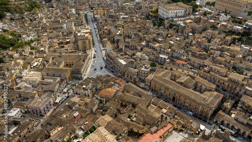 Fototapeta Naklejka Na Ścianę i Meble -  Aerial view of a road intersection in a small town. This street is located in the city of Modica, in the province of Ragusa, Sicily, Italy.