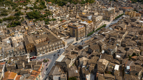 Fototapeta Naklejka Na Ścianę i Meble -  Aerial view of a road intersection in a small town. This street is located in the city of Modica, in the province of Ragusa, Sicily, Italy.