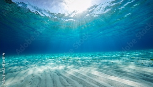 Sunbeams Filter Through The Crystal Clear Turquoise Water Illuminating The Pristine White Sand Seabed In A Serene And Inviting Underwater Seascape Scene