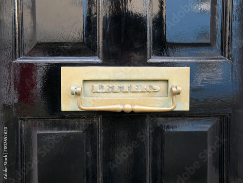 Fotografie Brass Letterbox and Knocker with “Letters” on a Black Painted Wooden Front Door,