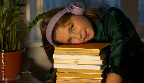 a teenage girl put her head on the books