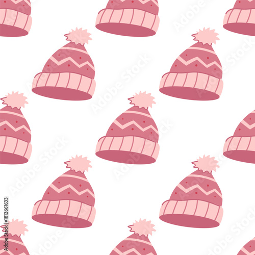 A cute winter seamless pattern with pink warm knitted hats with pom pom.