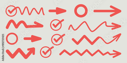 A collection of red arrows, circles and check marks in various styles on a white background surface