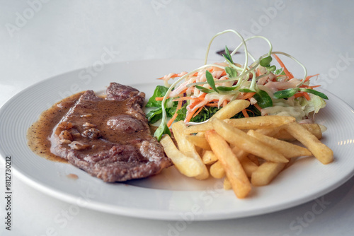 Close up of Grilled beef steak, boiled french fries and vegetable salad;Selective focus
