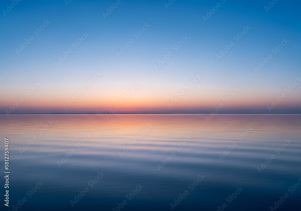 Fototapeta premium Serene expanse of water meets the horizon beneath a gradient sky