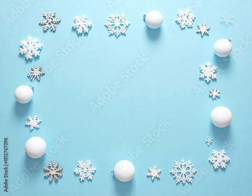 Festive Winter Snowflake and Snowball Border on Serene Blue Background.