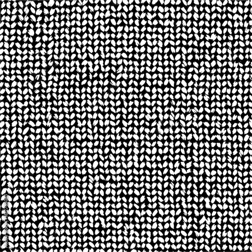 Dense monochrome pattern of repeating leaf shapes arranged in rows and columns on a black background