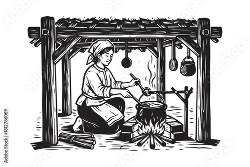Woman cooking over open fire in rustic hut
