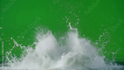 Explosion of water droplets and foam against a vibrant green screen background, capturing a dynamic splash