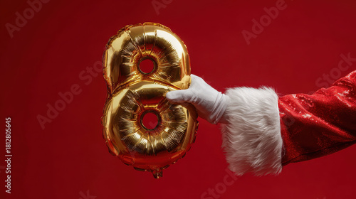 Santa claus hand holding a golden number 8 balloon for the twelve days of christmas