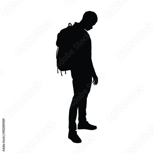 Silhouette of a young man wearing a backpack, standing and looking down in a pensive or contemplative pose. Ideal for themes related to travel, education, loneliness, contemplation, or journey.