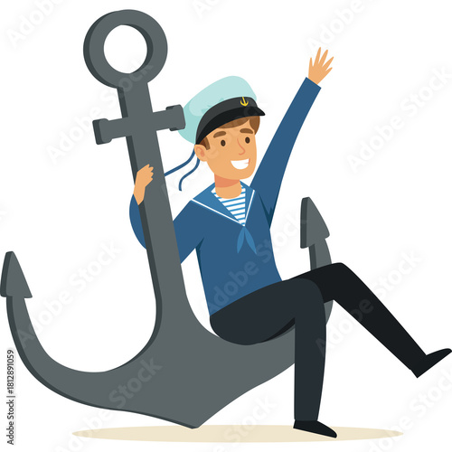 Smiling young man dressed as a sailor sits on a large grey anchor wearing a blue uniform with white stripes on his shirt and a white hat with a blue band and emblem waving his right hand joyfully