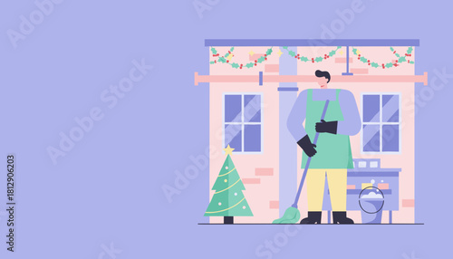 Worker sweeping outside building decorated for Christmas holidays