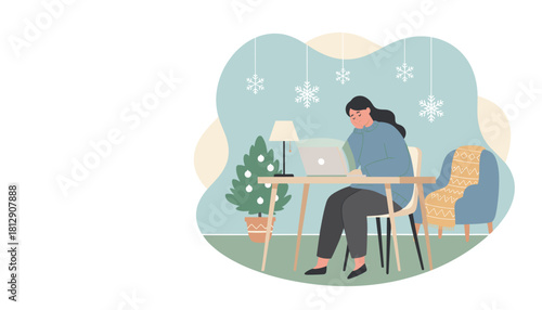 Woman working remotely on a laptop in a cozy winter home office decorated for Christmas