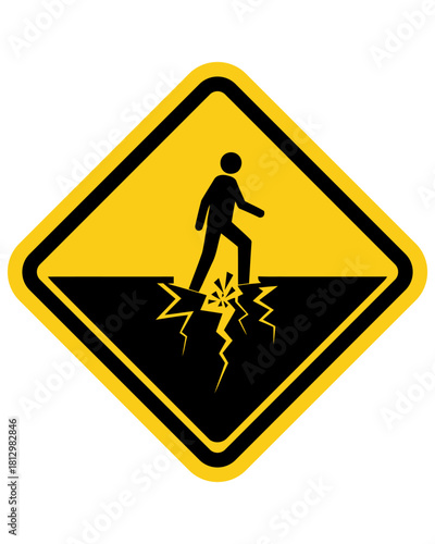 Cautionary yellow diamond warning sign depicting a stylized person stepping on cracked ground, signifying a potential hazard or danger ahead on a pathway or surface