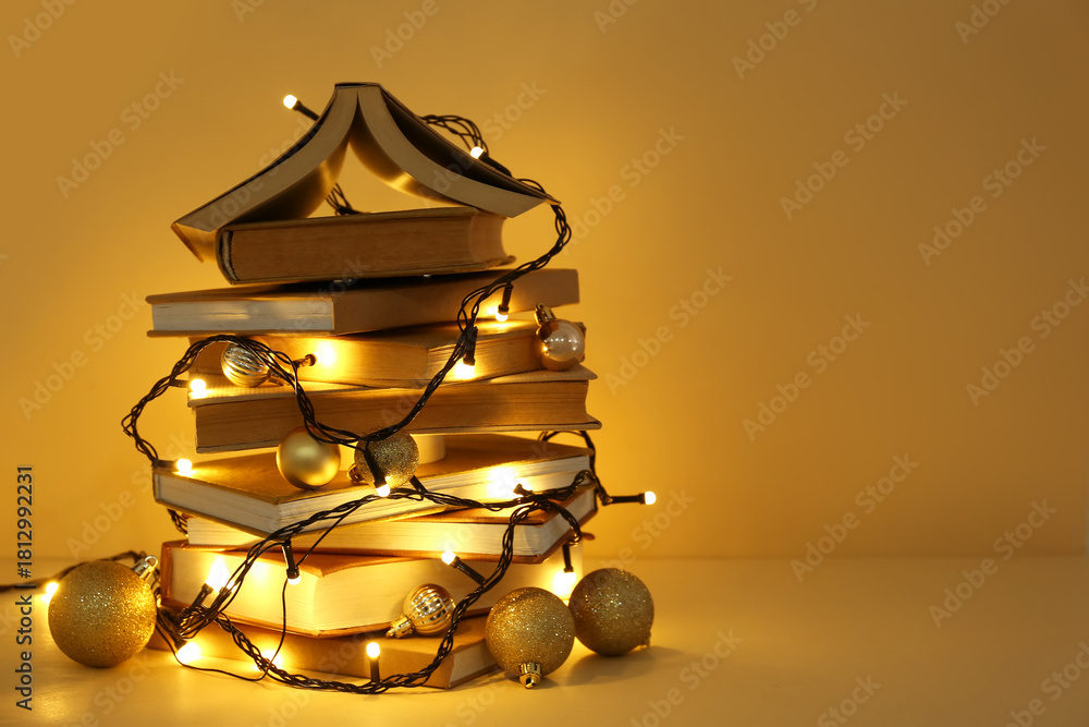 Fototapeta premium Christmas tree made of different books and garland on yellow background