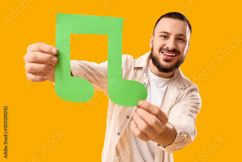 Young man with paper music ...