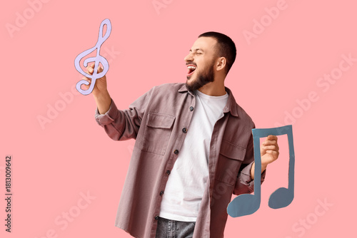 Young man with paper music ...