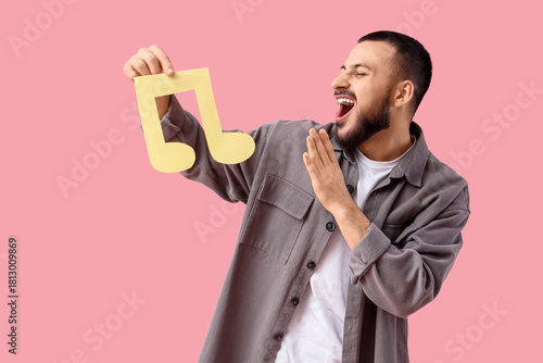 Young man with paper music ...