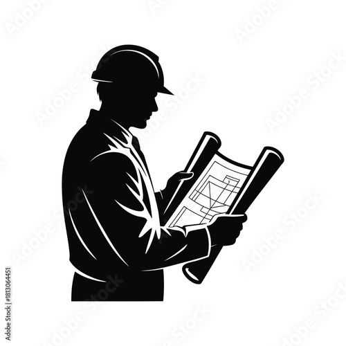 Silhouette of an architect wearing a hard hat examining blueprints for a building project