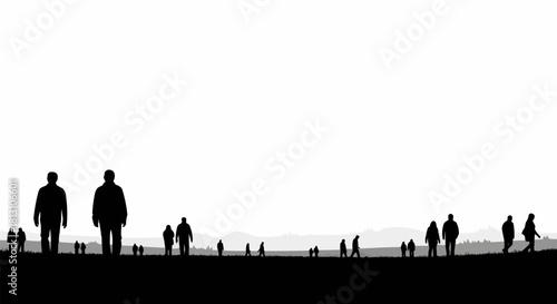 Silhouettes of people walking on a dark ground against a bright white sky.