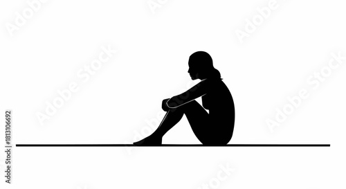 Silhouette of a Person Sitting with Knees Drawn Upward in Contemplation.