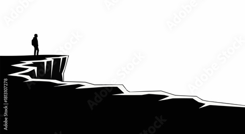 Silhouette of a person standing on the edge of a cliff contemplating.