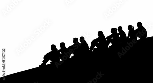 Group of people sitting on a hill in silhouette.