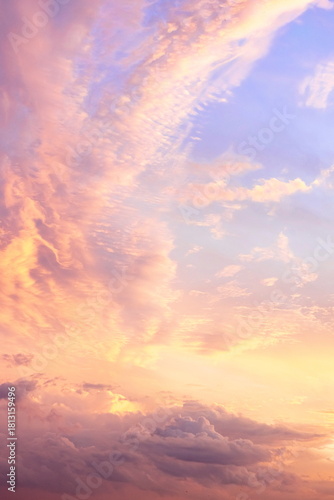 Beautiful sunset with vibrant clouds and pastel colors over the horizon during late evening in a serene sky