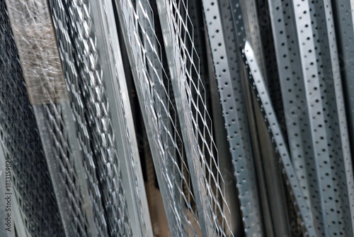 Metal materials stacked neatly in a warehouse ready for construction projects during daytime hours