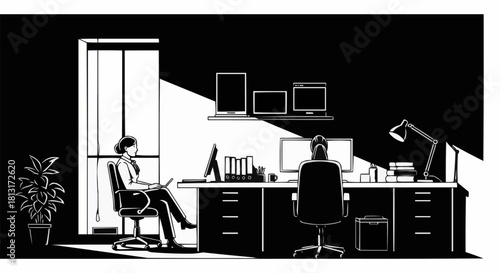 Two women working diligently at their desks in a modern office setting.