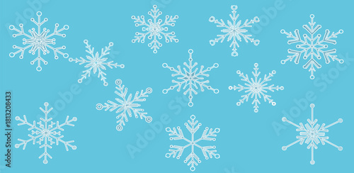 A Collection of Intricate White Snowflakes Scattered Across a Light Blue Background, Evoking a Winter Wonderland Atmosphere