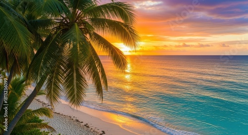 Fototapeta Naklejka Na Ścianę i Meble -  Beautiful tropical beach sunset with palm trees and golden light reflecting on water