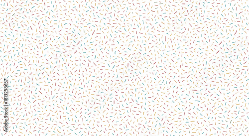 A seamless pattern background of colorful confetti or dessert sprinkles scattered on a white surface for festive celebrations.