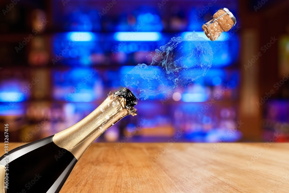 Obraz premium A champagne bottle popping its cork, with bubbles and spray emerging, symbolizing celebration and joy in a festive atmosphere